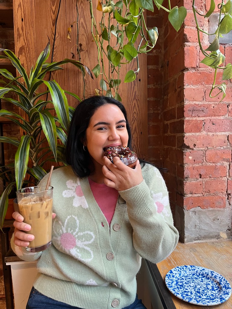 enjoying vegan donut at vegan cafe